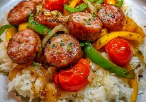 Sausage, Onion, Bell Peppers & Tomatoes over Rice